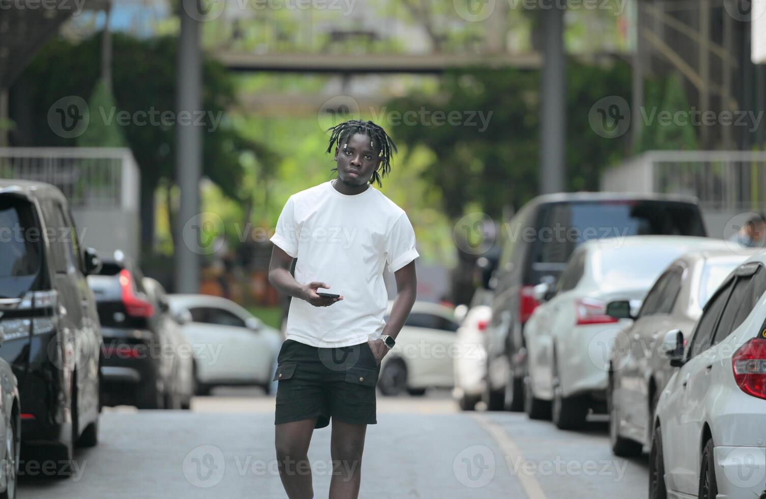 A young man with his hairstyle and the atmosphere of living in the community. photo