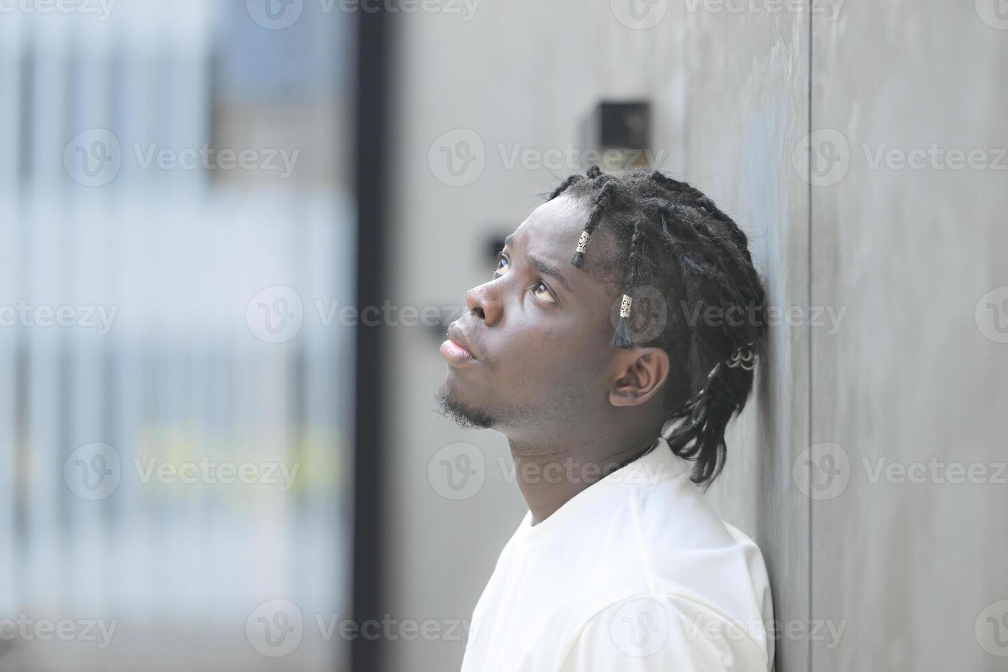 A young man with his hairstyle and the atmosphere of living in the community. photo