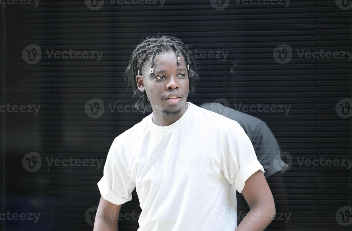 A young man with his hairstyle and the atmosphere of living in the community. photo