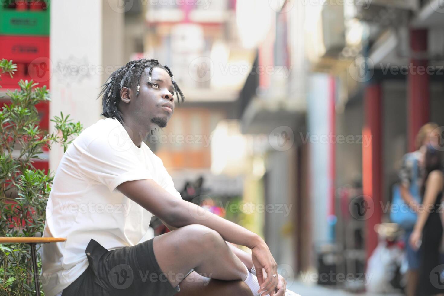 A young man with his hairstyle and the atmosphere of living in the community. photo