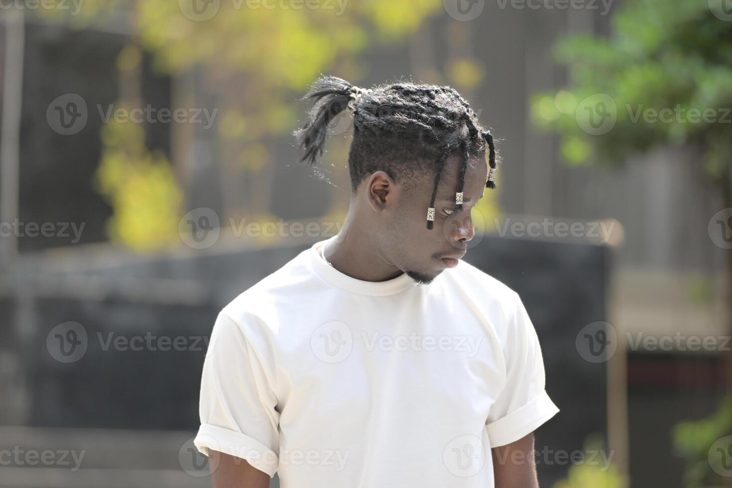 A young man with his hairstyle and the atmosphere of living in the community. photo