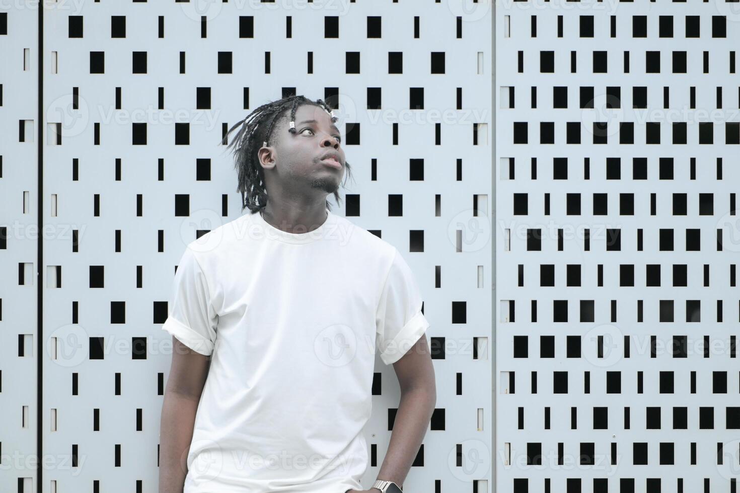 A young man with his hairstyle and the atmosphere of living in the community. photo