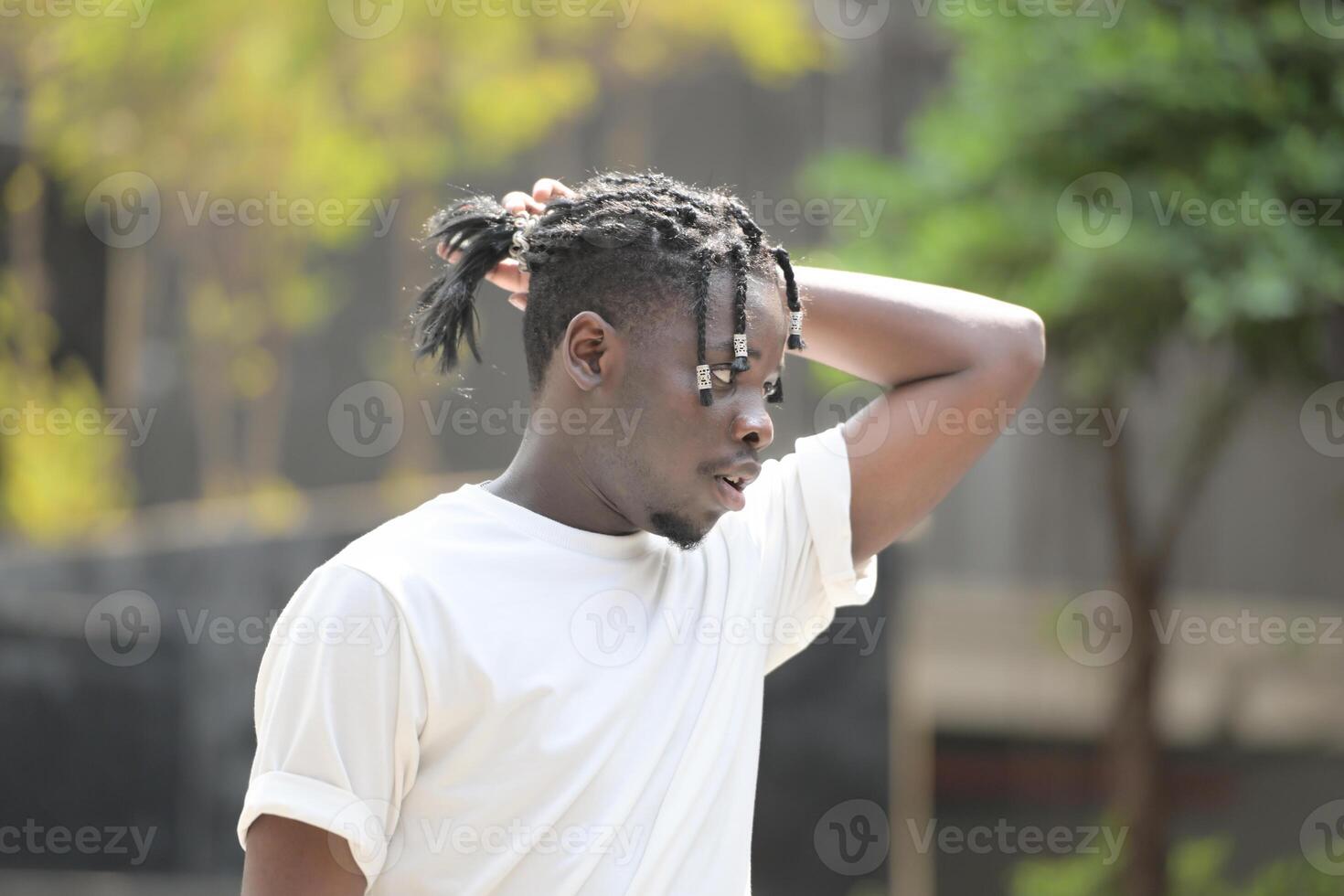 A young man with his hairstyle and the atmosphere of living in the community. photo