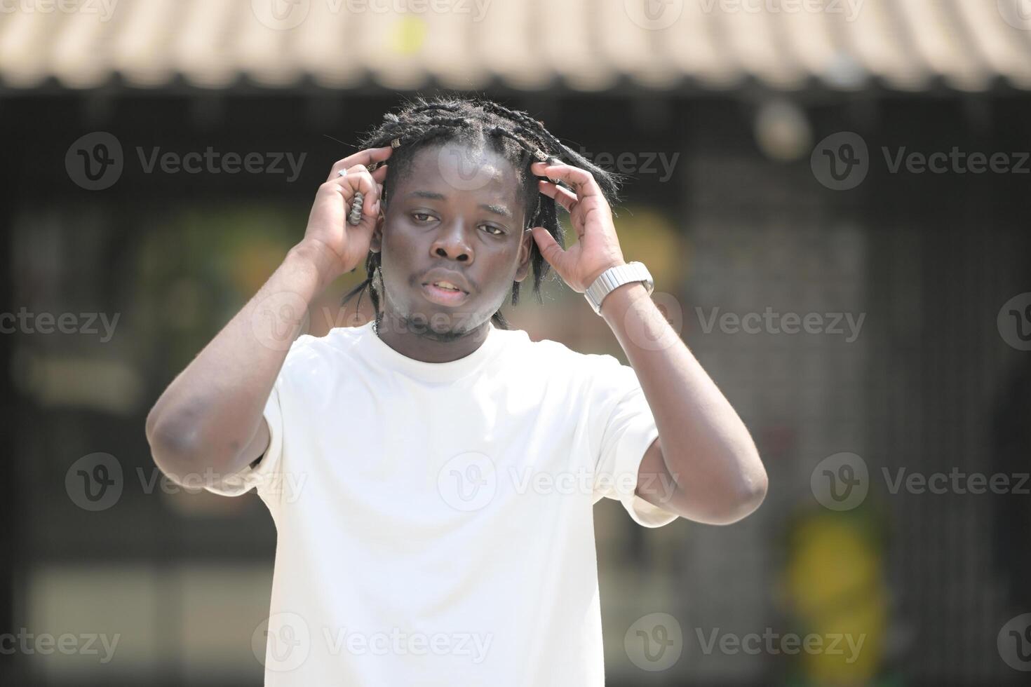 A young man with his hairstyle and the atmosphere of living in the community. photo