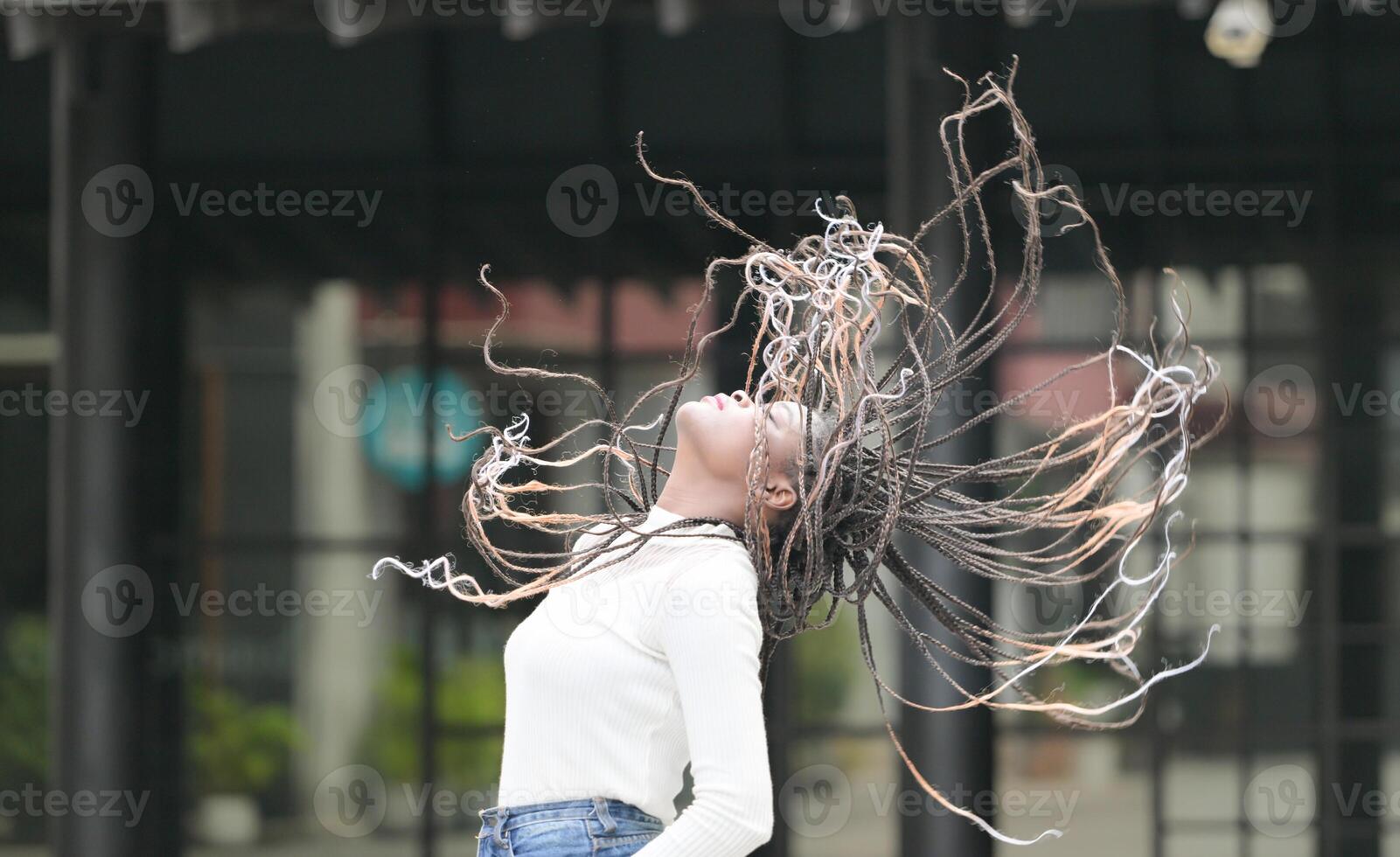 A young woman with his hairstyle and the atmosphere of living in the community. photo