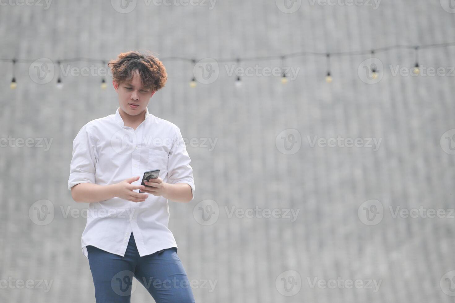 A young man with his hairstyle and the atmosphere of living in the community. photo