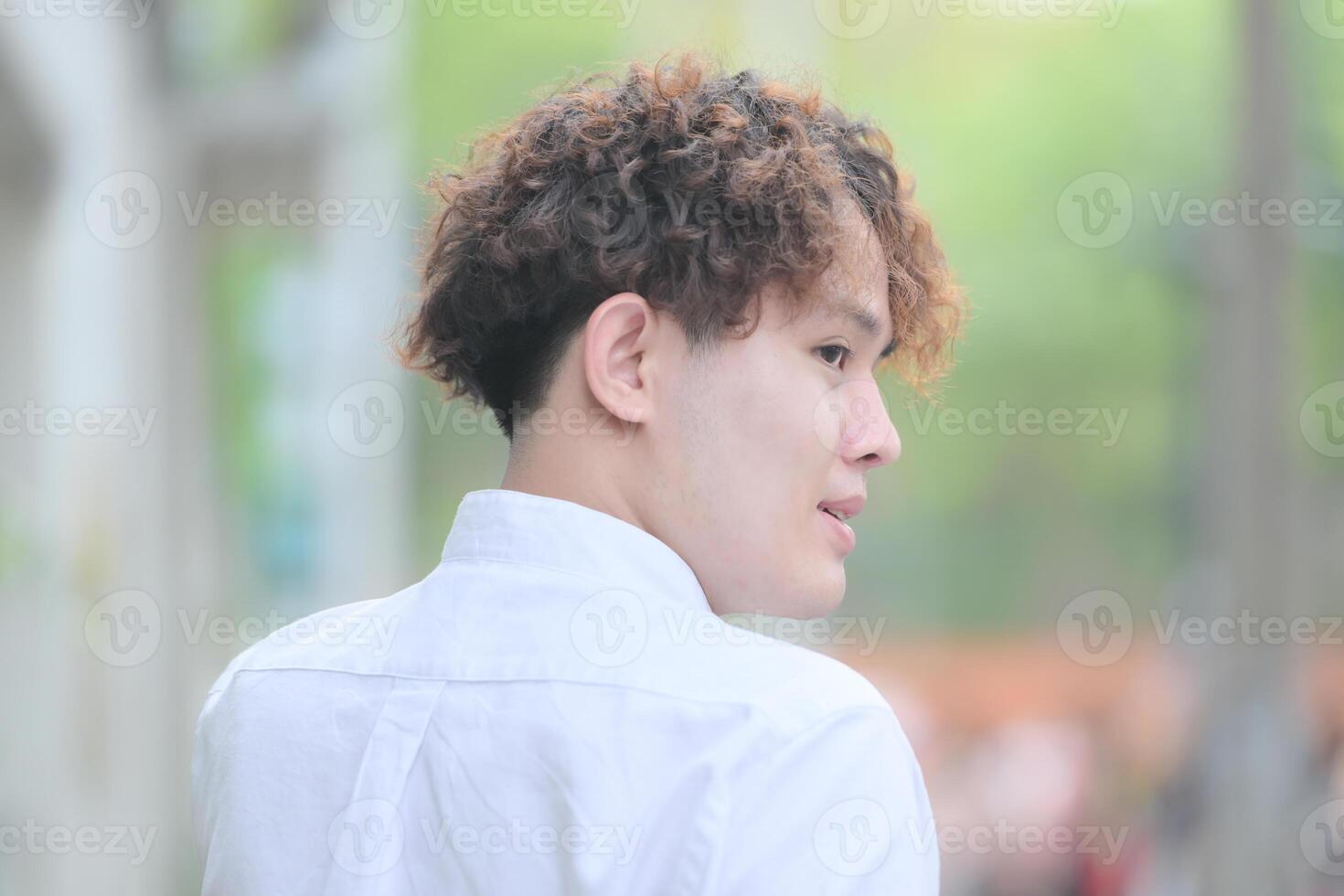 A young man with his hairstyle and the atmosphere of living in the community. photo