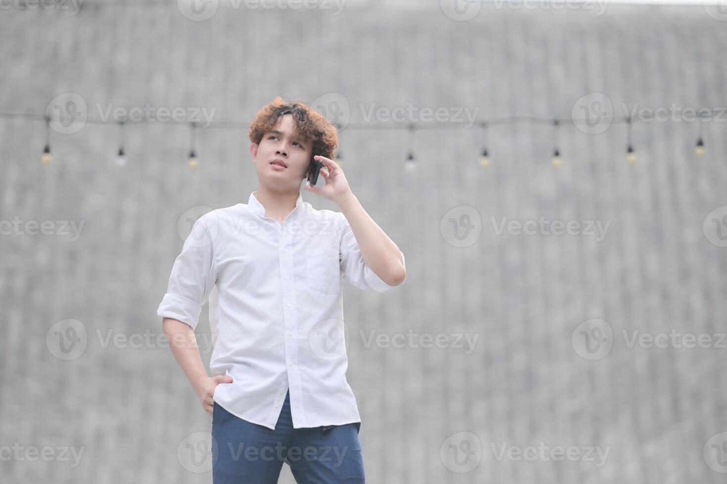 A young man with his hairstyle and the atmosphere of living in the community. photo