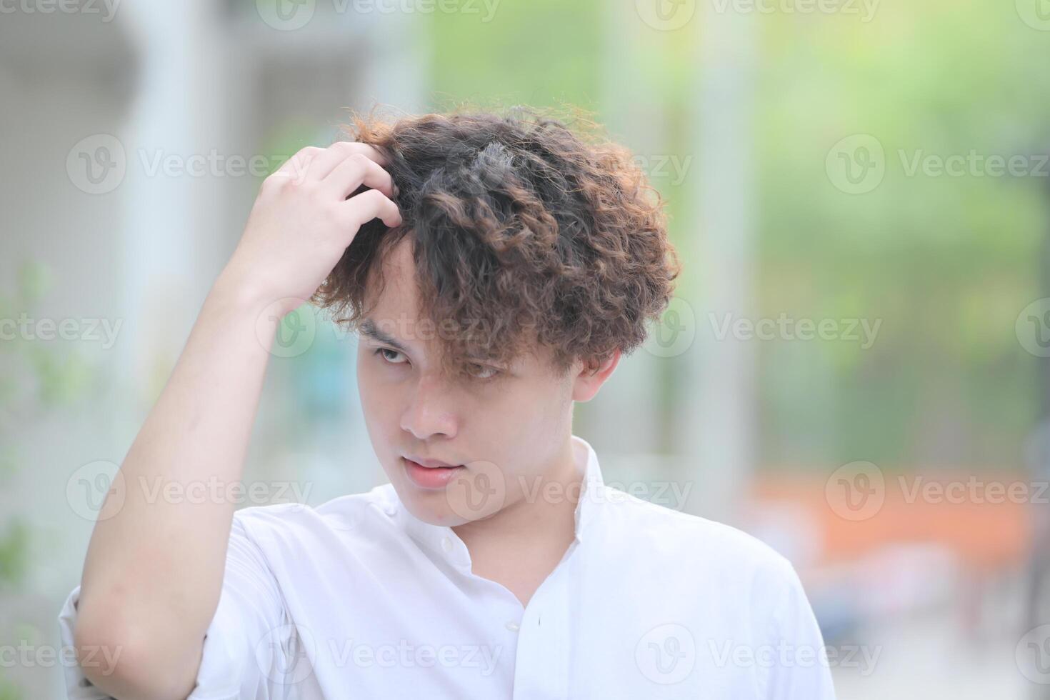 A young man with his hairstyle and the atmosphere of living in the community. photo