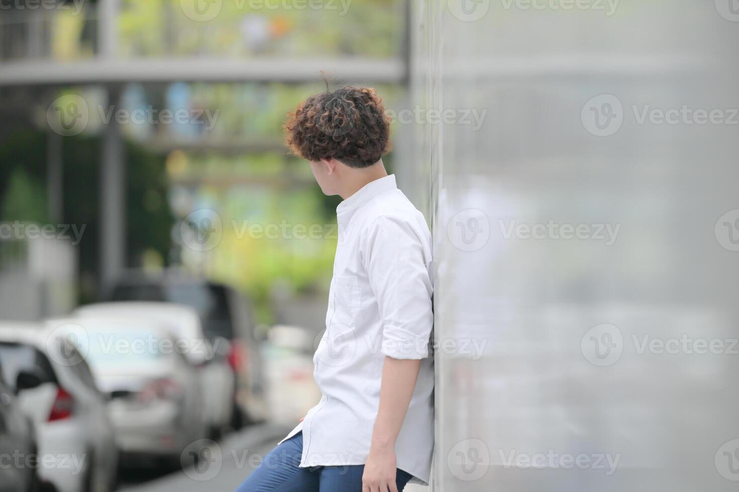 A young man with his hairstyle and the atmosphere of living in the community. photo