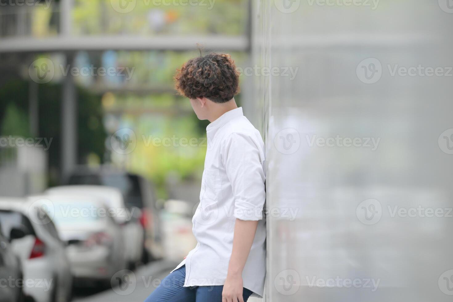 A young man with his hairstyle and the atmosphere of living in the community. photo