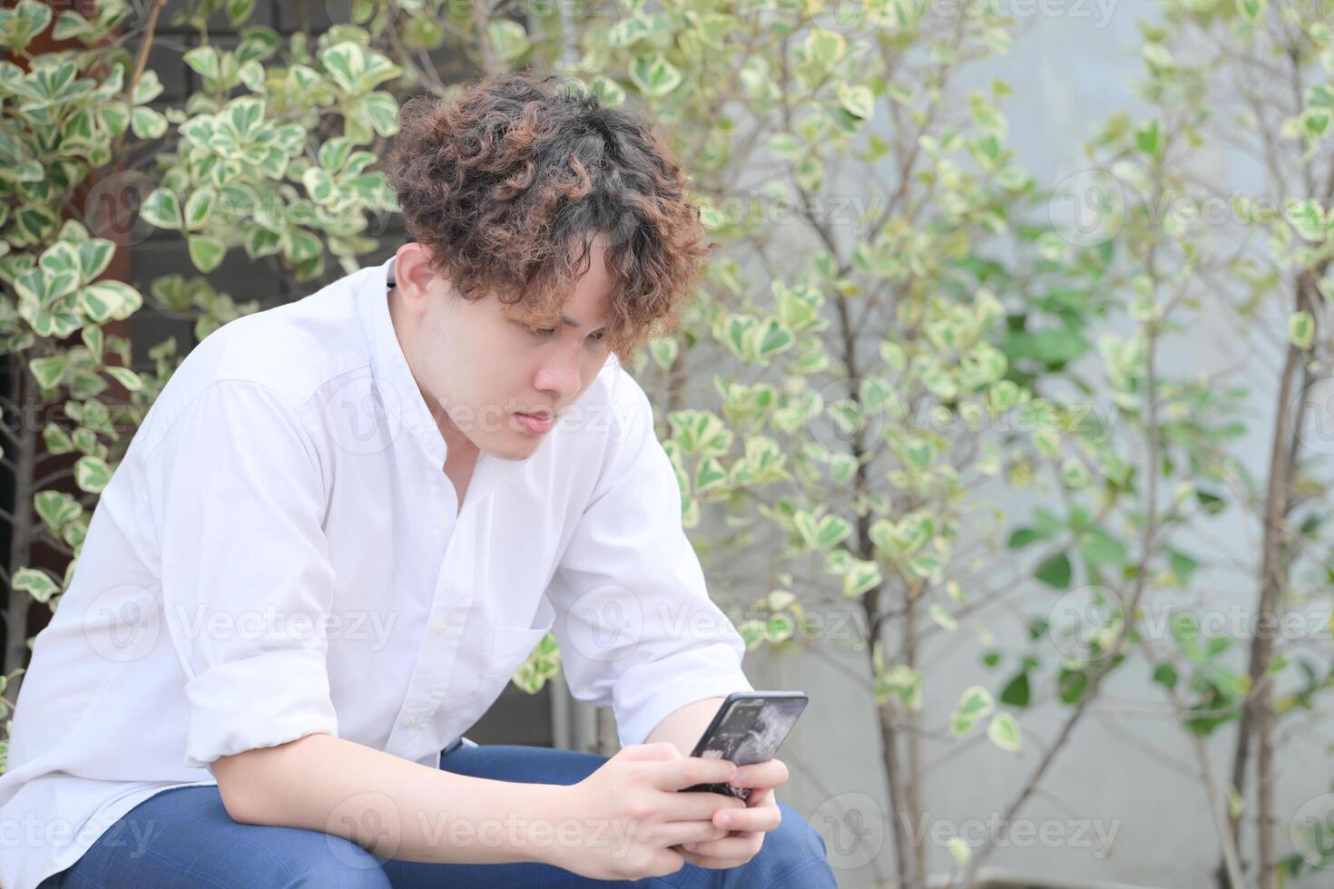 A young man with his hairstyle and the atmosphere of living in the community. photo
