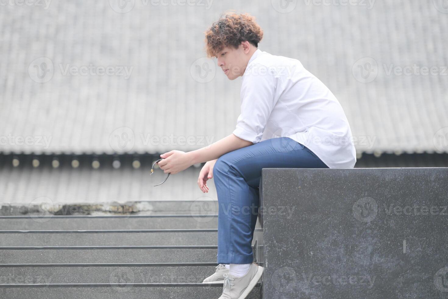 A young man with his hairstyle and the atmosphere of living in the community. photo