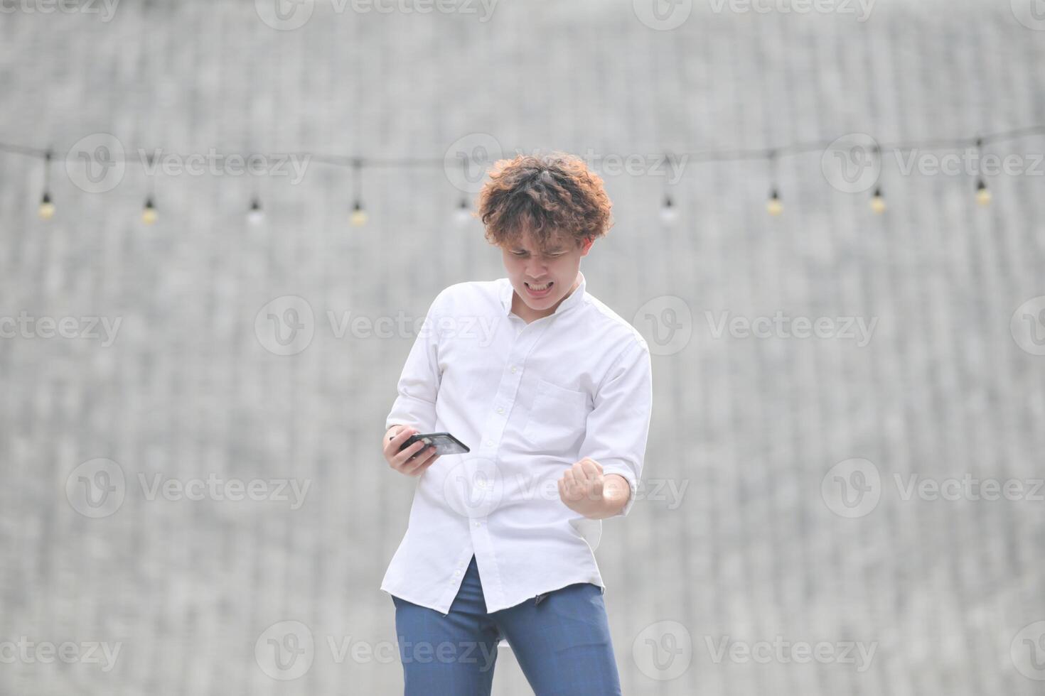 A young man with his hairstyle and the atmosphere of living in the community. photo