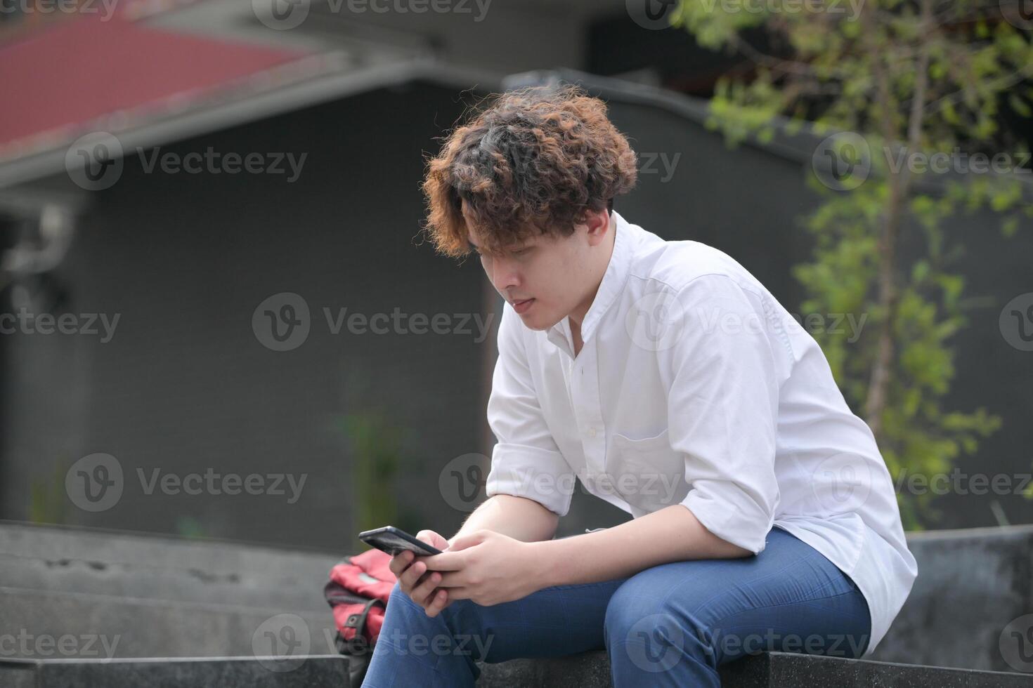 A young man with his hairstyle and the atmosphere of living in the community. photo