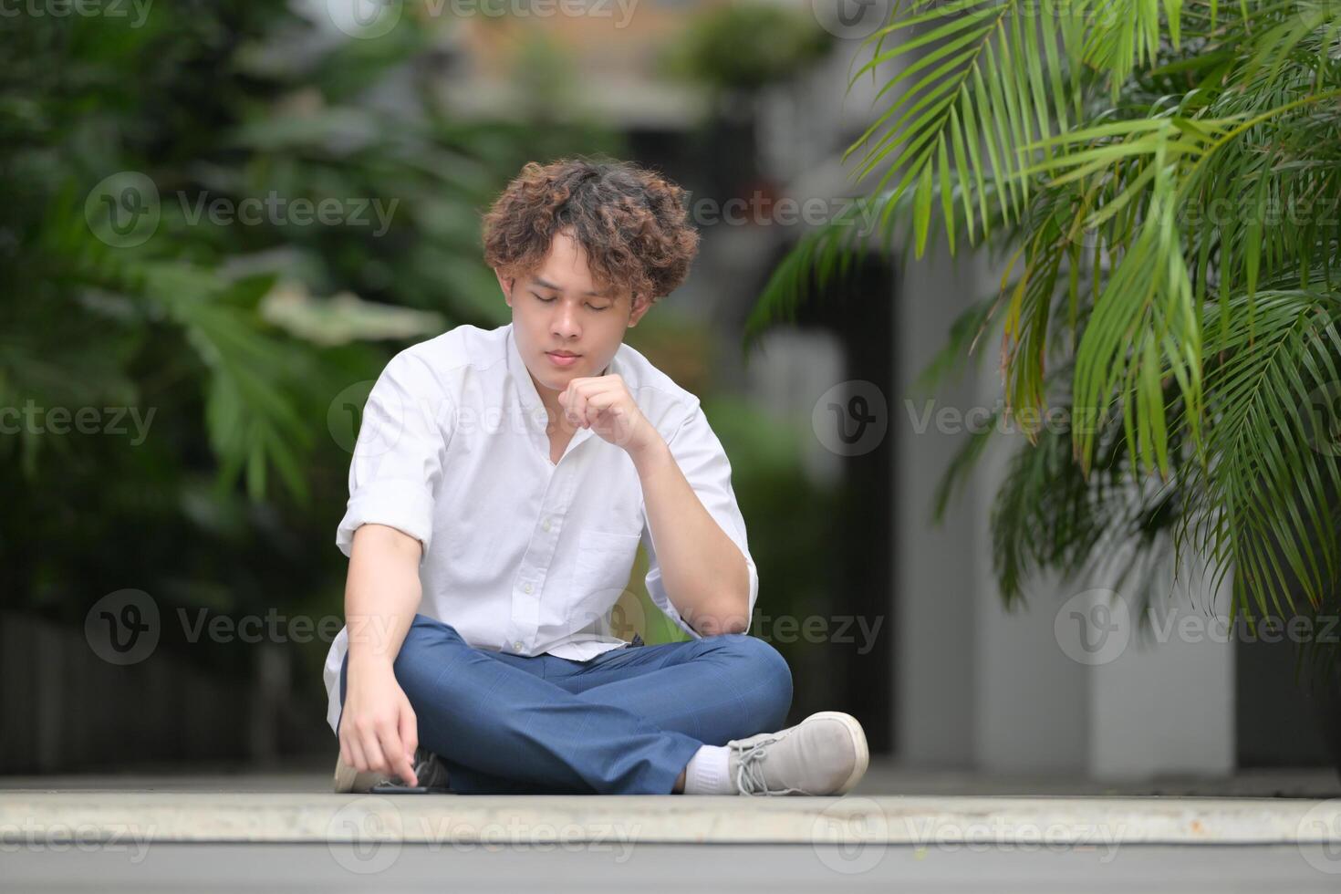 A young man with his hairstyle and the atmosphere of living in the community. photo