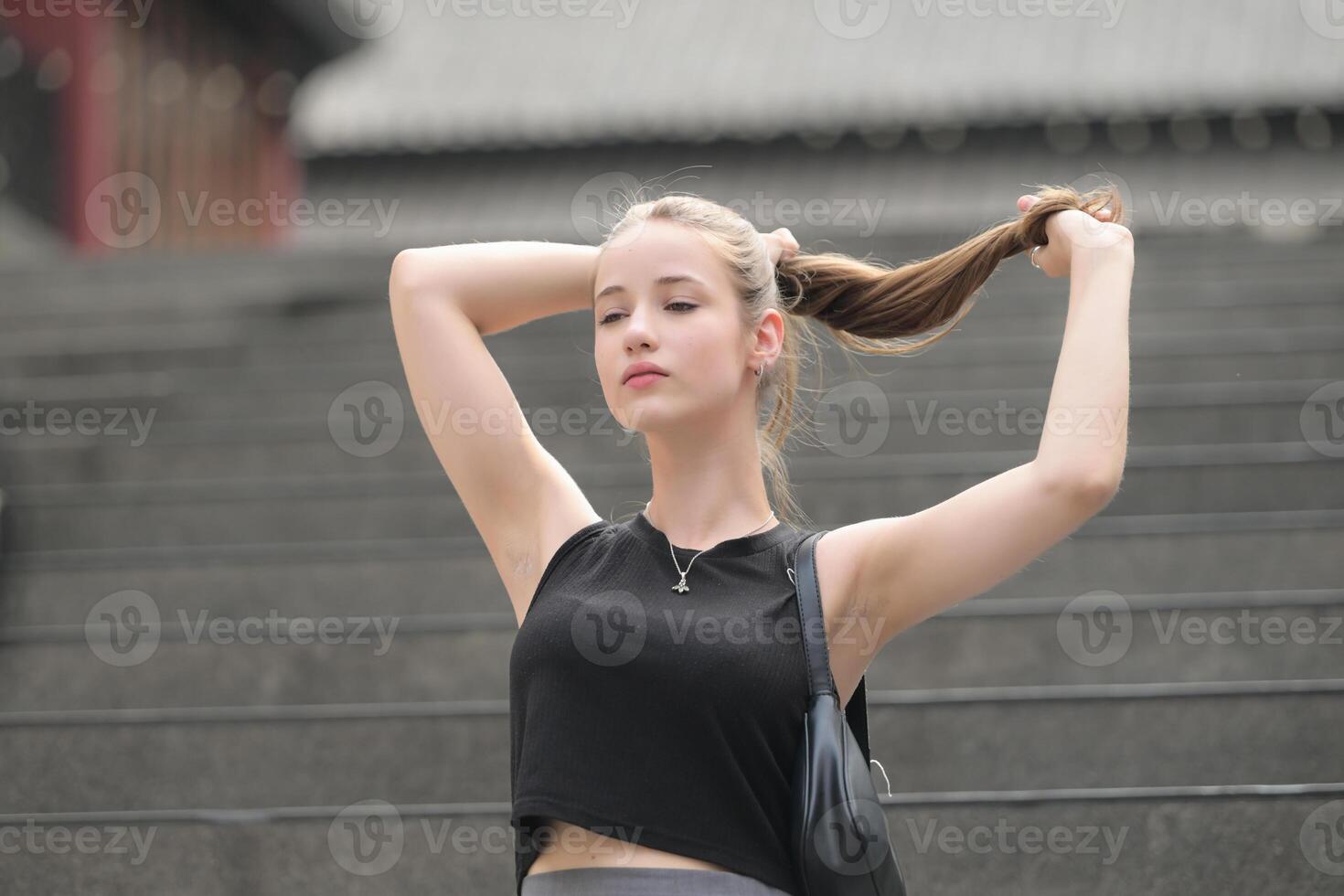 A young woman with his hairstyle and the atmosphere of living in the community. photo