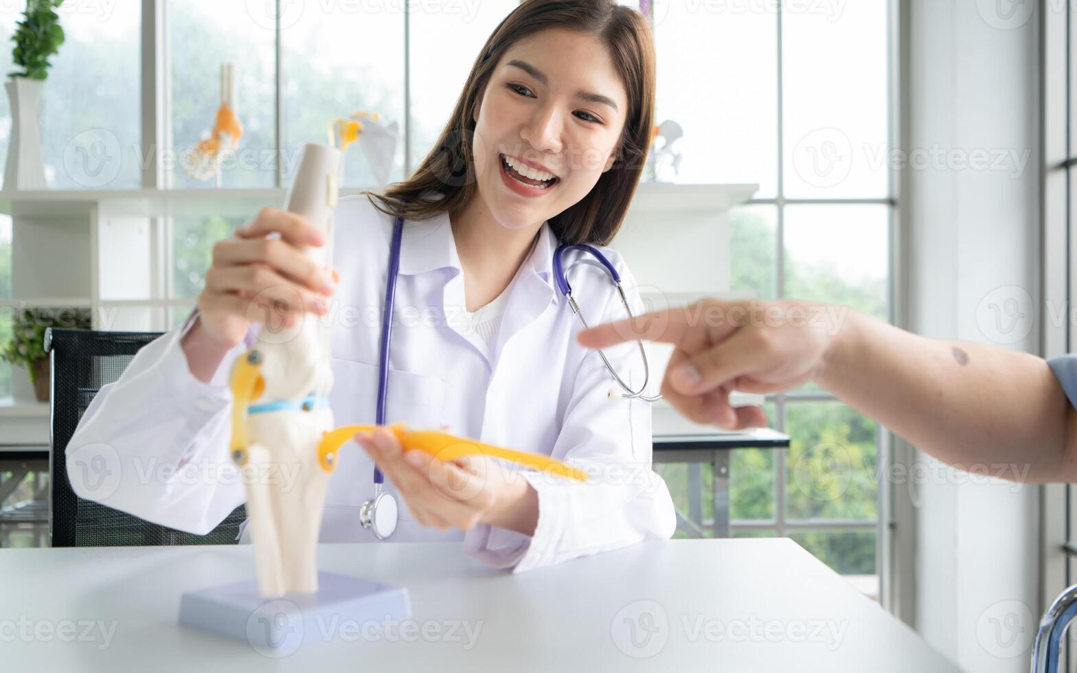 In the hospital office, A medical explains about the care and treatment of osteoarthritis to a patient photo