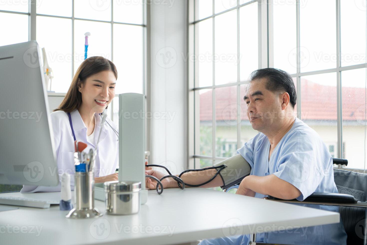 Doctor using a blood pressure monitor on a patient photo