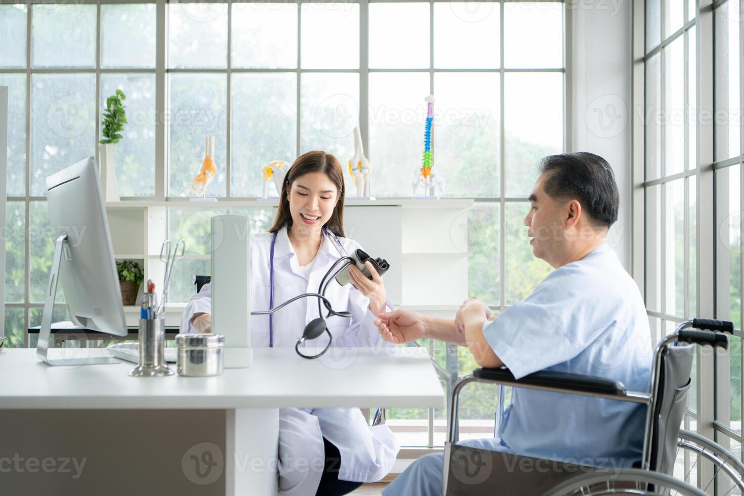 Doctor using a blood pressure monitor on a patient photo