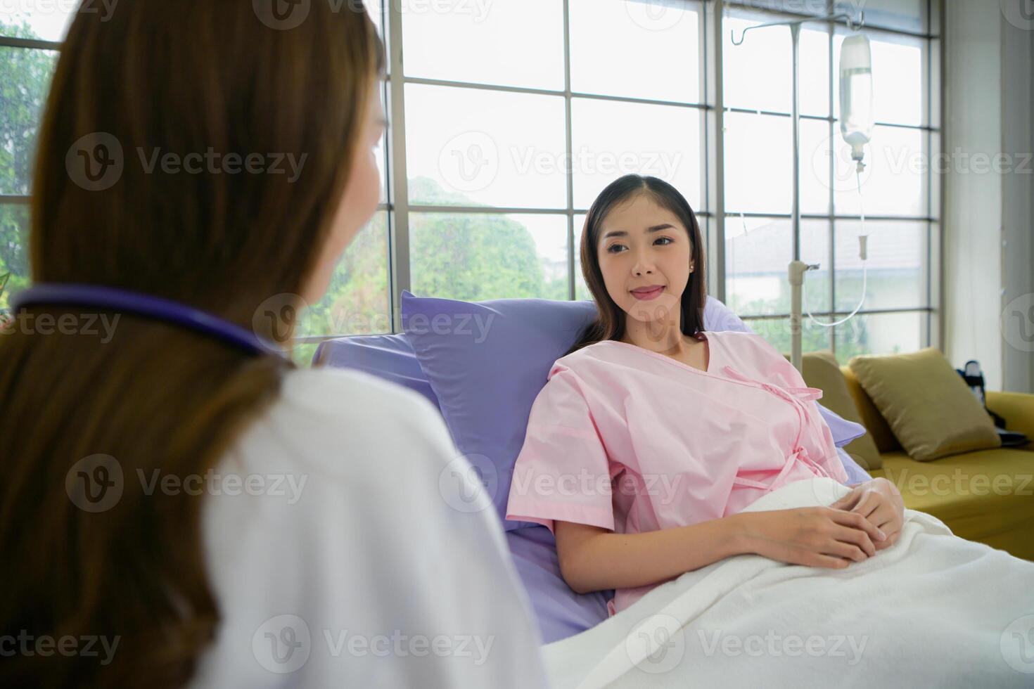 Female doctor with IV equipment will give IV fluids and examine patients lying in hospital beds photo