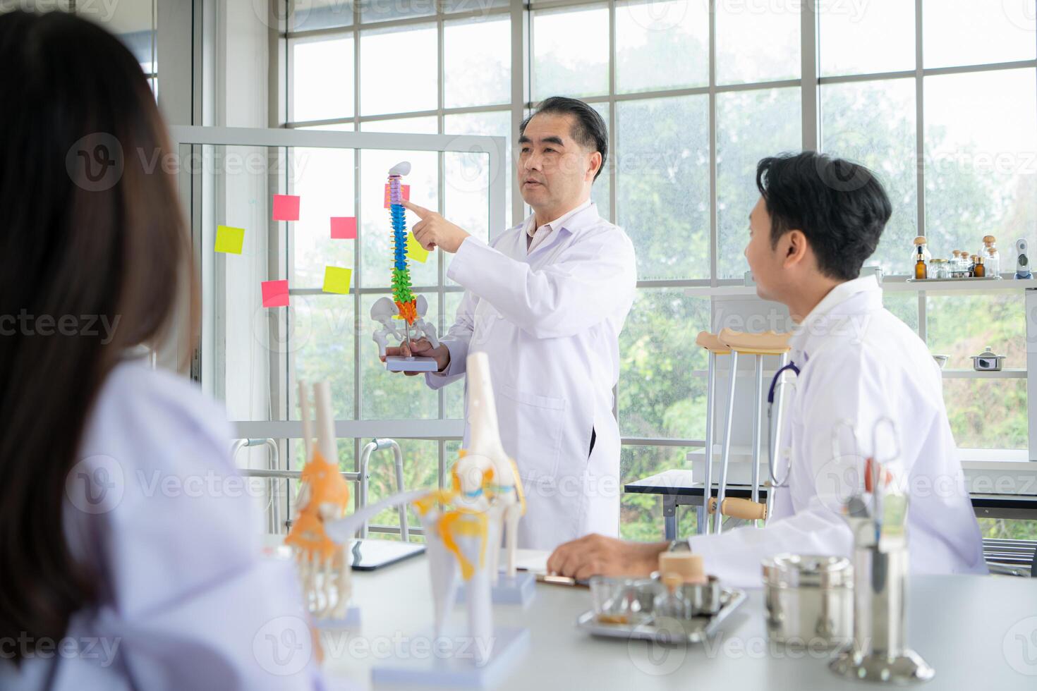 A medical professor is lecturing on a case study related to disease treatment to medical students photo