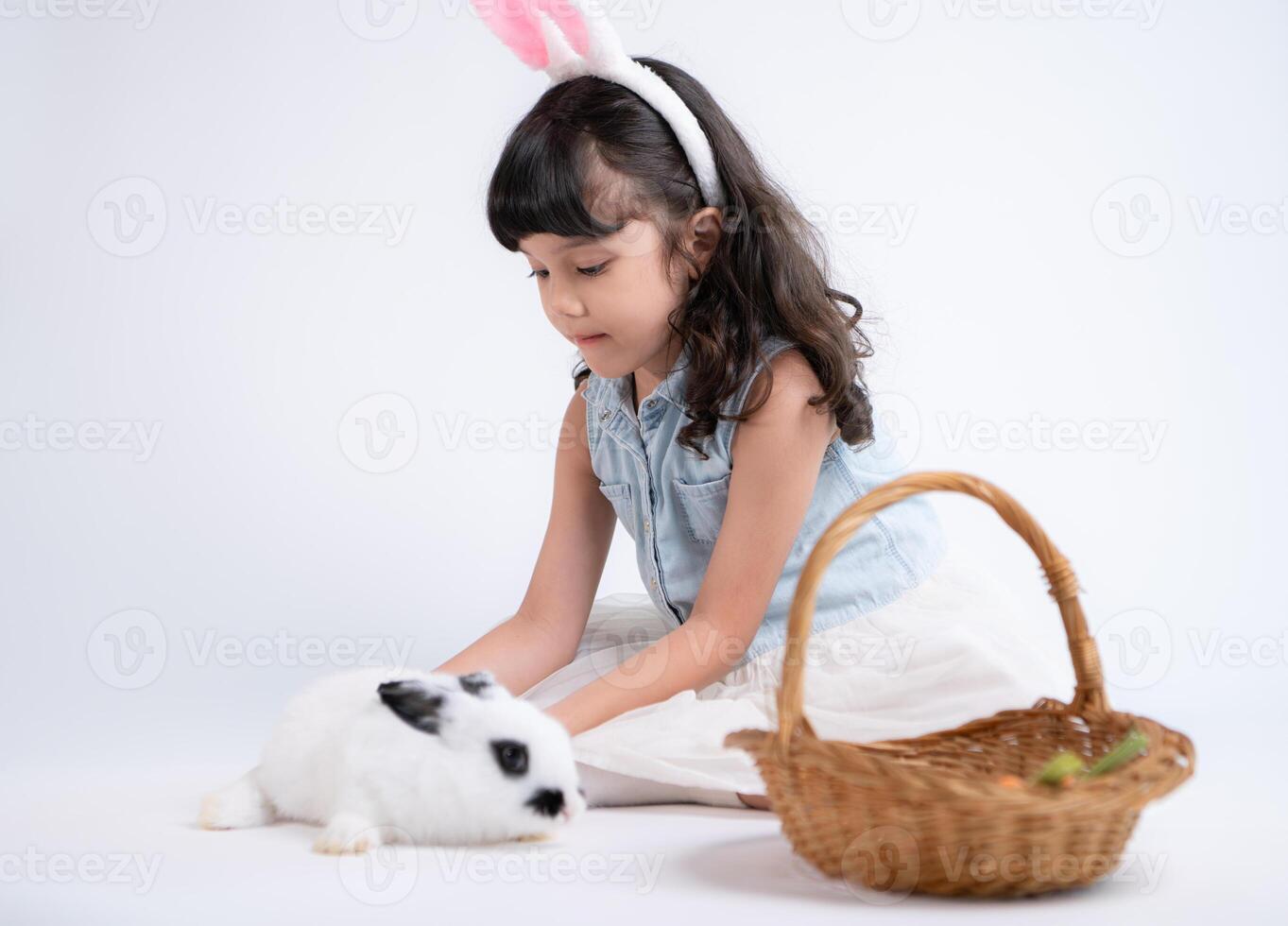 Smiling little girl and with their beloved fluffy rabbit, showcasing the beauty of friendship between humans and animals photo