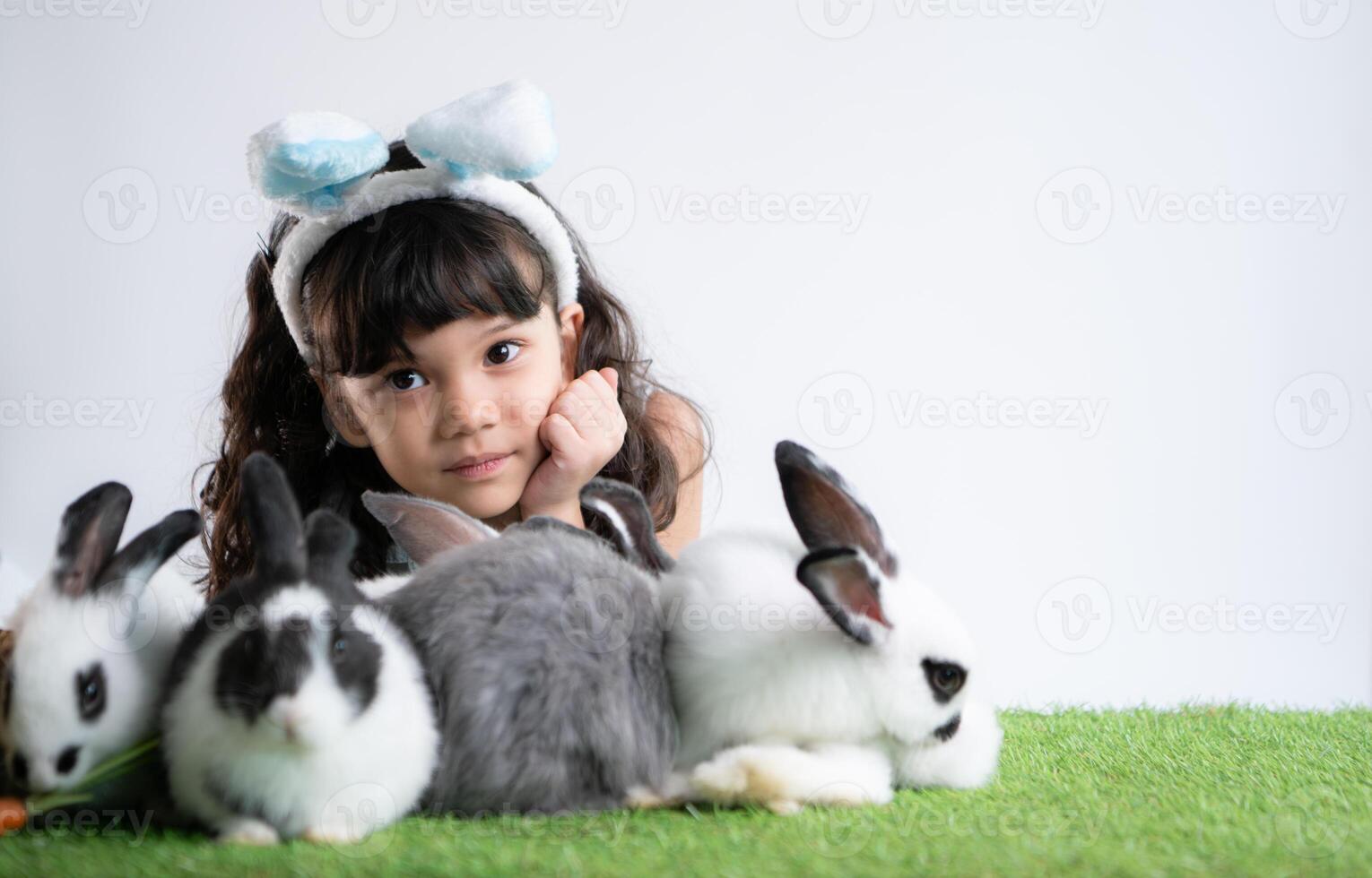 Smiling little girl and with their beloved fluffy rabbit, showcasing the beauty of friendship between humans and animals photo