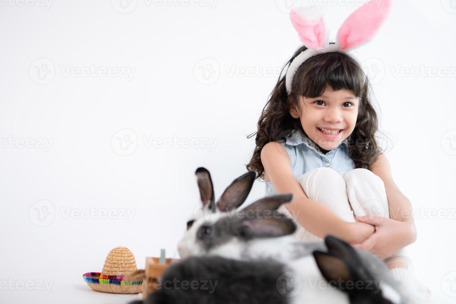 Smiling little girl and with their beloved fluffy rabbit, showcasing the beauty of friendship between humans and animals photo