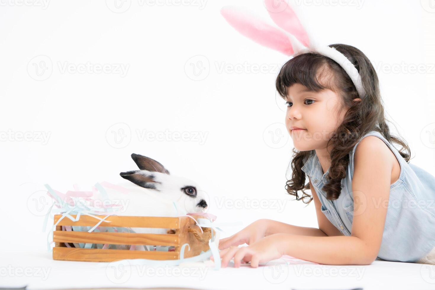 Smiling little girl and with their beloved fluffy rabbit, showcasing the beauty of friendship between humans and animals photo