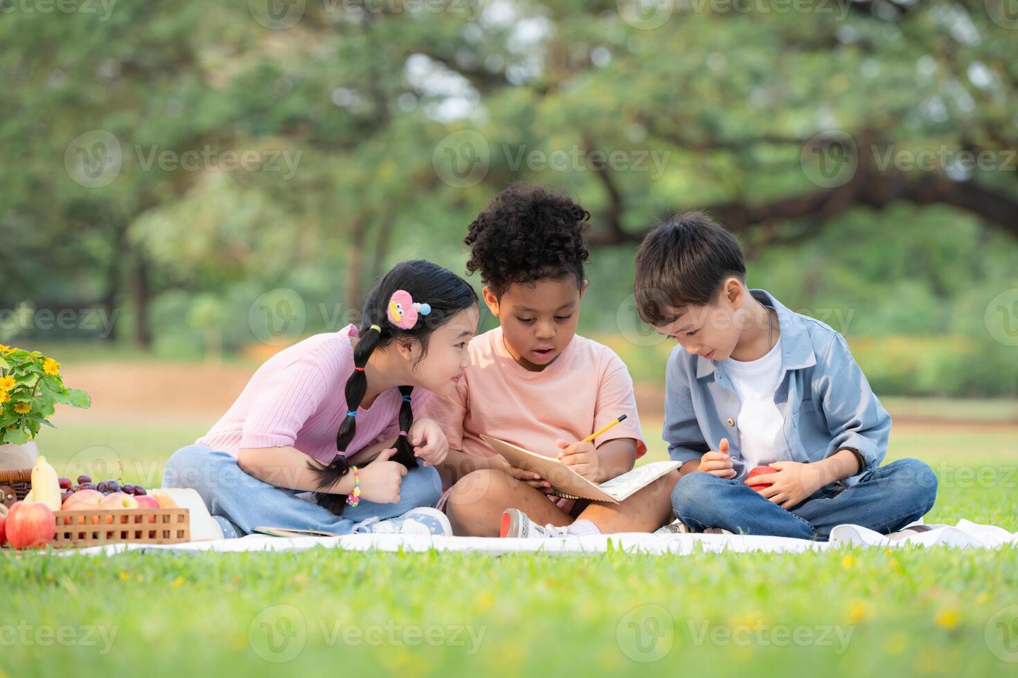 Happy family enjoying a picnic in the park, Children are having fun drawing on paper. photo