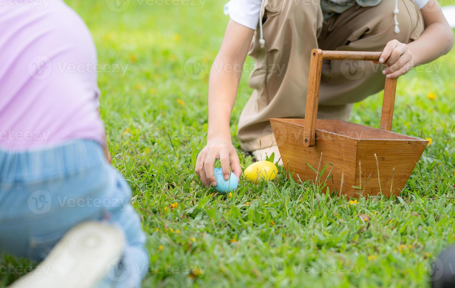 Children enjoying outdoor activities in the park including a run to collect beautiful Easter eggs. photo