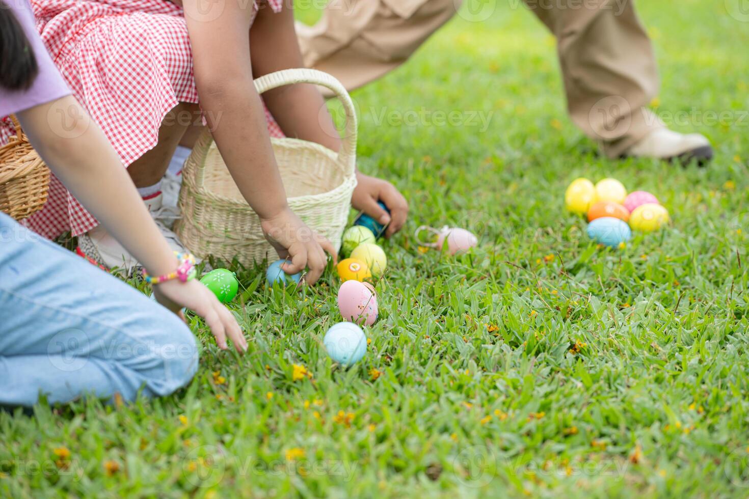 Children enjoying outdoor activities in the park including a run to collect beautiful Easter eggs. photo