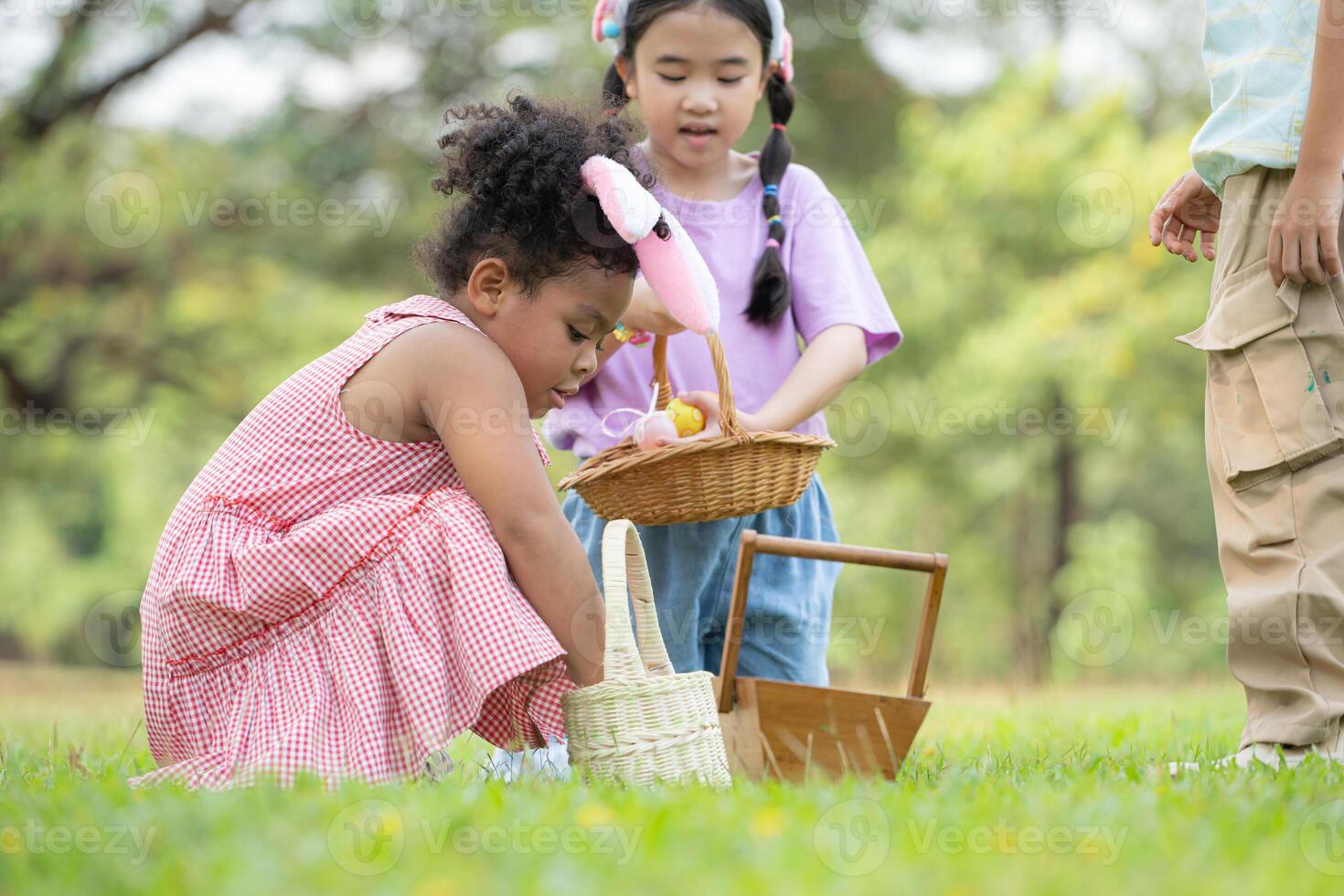 Children enjoying outdoor activities in the park including a run to collect beautiful Easter eggs. photo