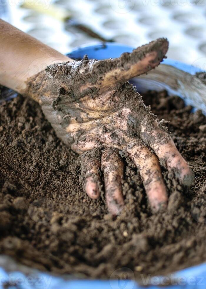 Opened Hand with wet soil. Earth day concept photo