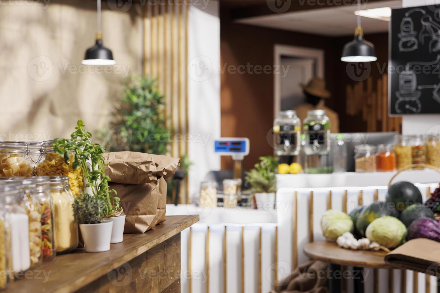 Products sold in bulk in empty zero waste shop to minimize plastic usage, reducing pollution for a sustainable lifestyle. Organic vegan pantry staples ready to be bought by consciously living clients photo