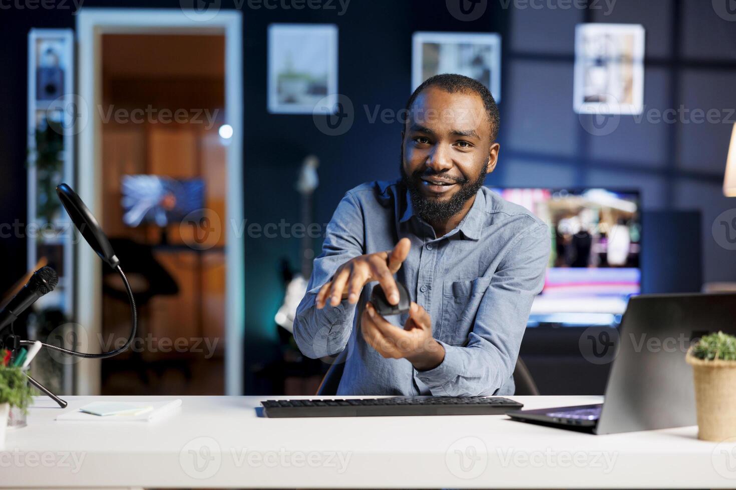 Internet show host being sponsored by partnering brand to do wireless mouse unboxing content. Tech specialist does influencer marketing, doing Bluetooth computer peripheral product placement photo