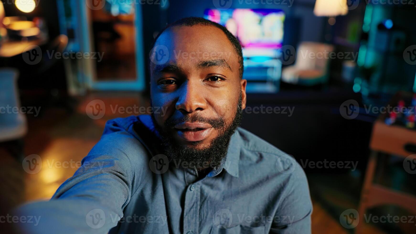 Point of view shot of content creator using smartphone to do live broadcast for subscribers, showing his home studio. Online star films himself for viewership using cellphone camera, POV perspective photo