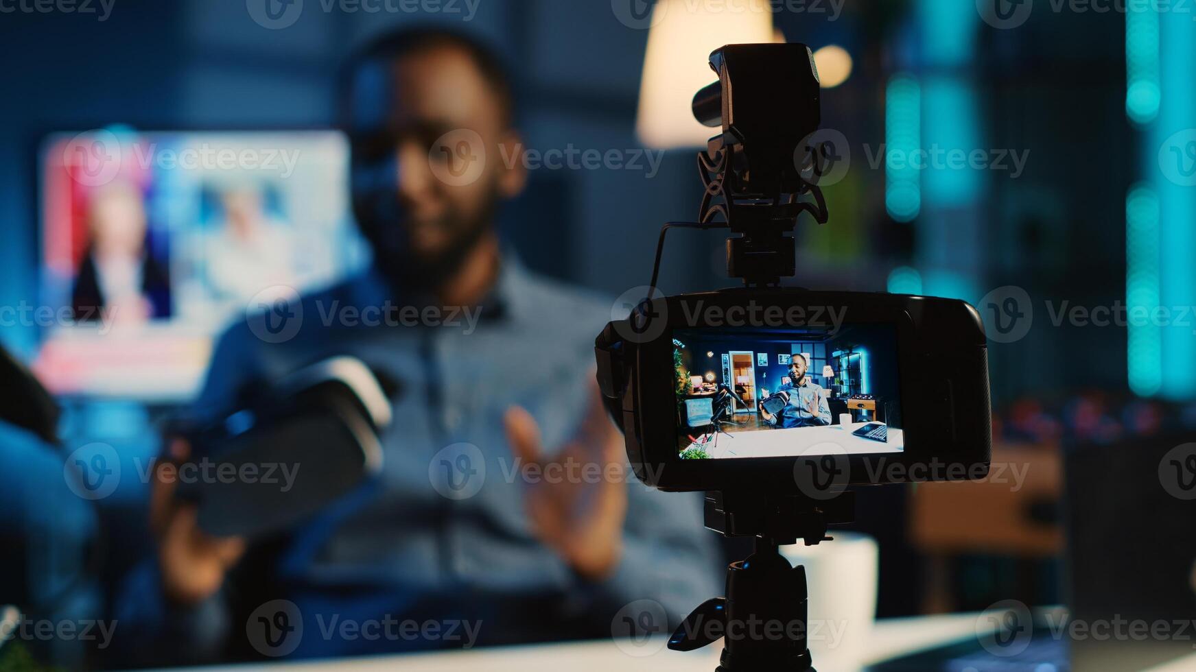 Tech content creator filming technology review of newly released gaming VR glasses for audience. African american influencer showing virtual reality goggles to subscribers photo