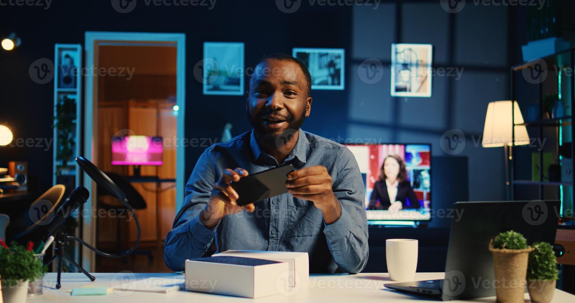 Content creator sponsored by tech brand to film unboxing review of their newly released smartphone. Influencer showing phone recommendation to viewers doing research before purchase photo