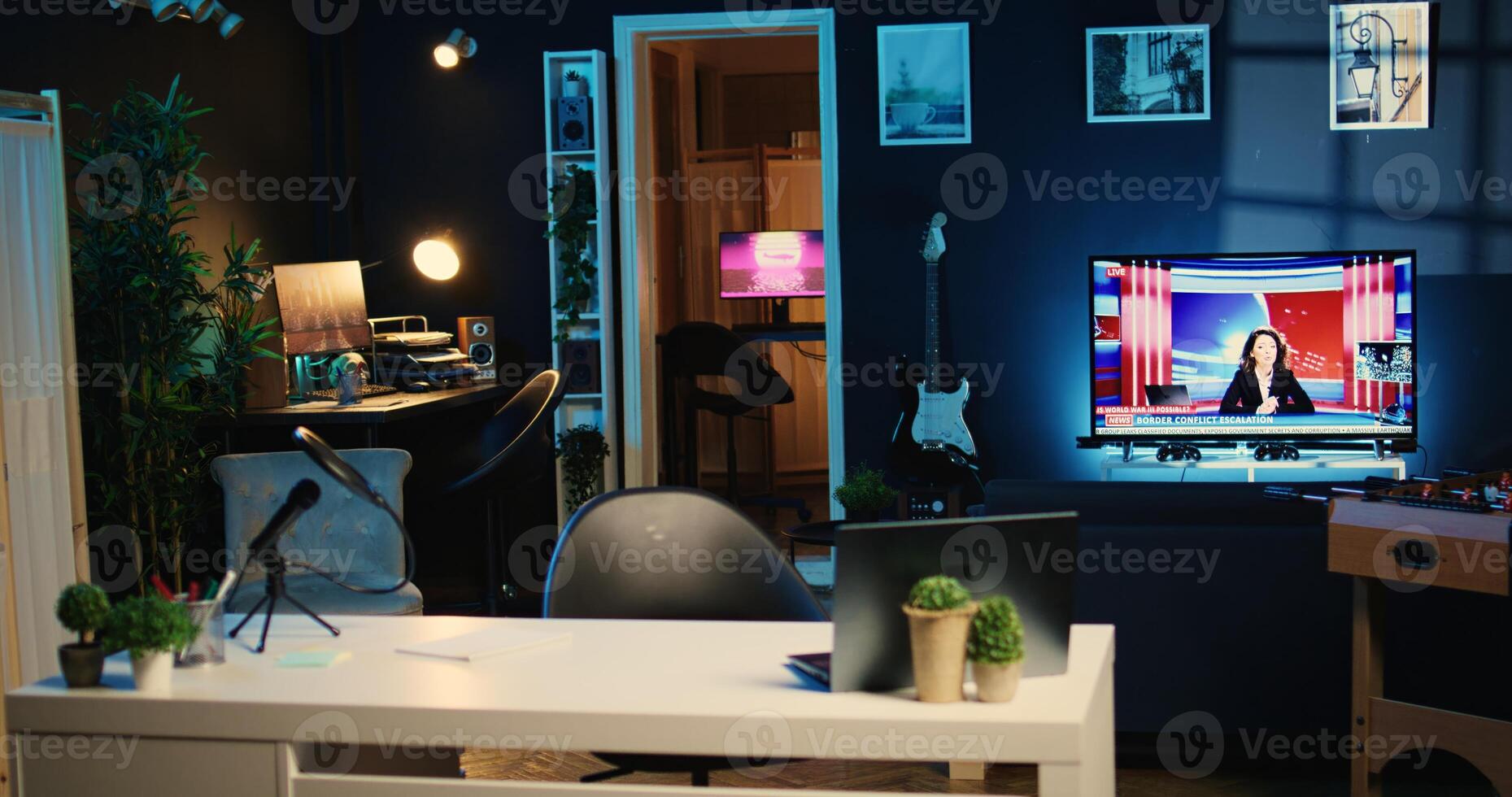 Empty cozy home studio interior with professional recording devices used for internet show production. Apartment filled with tech equipment, TV running in background and animations on computer screens photo
