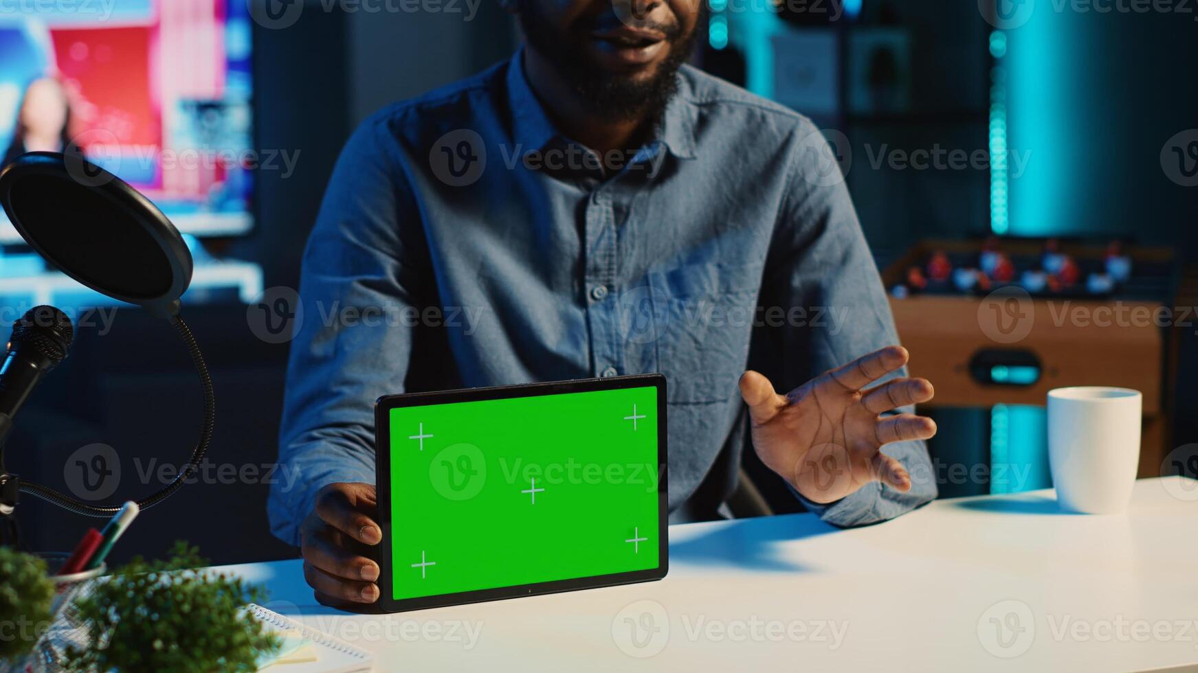 Content creator films chroma key tablet video review for tech enthusiasts using recording gadgets. Viral online star hosts social media internet show, unboxing green screen digital device, close up photo