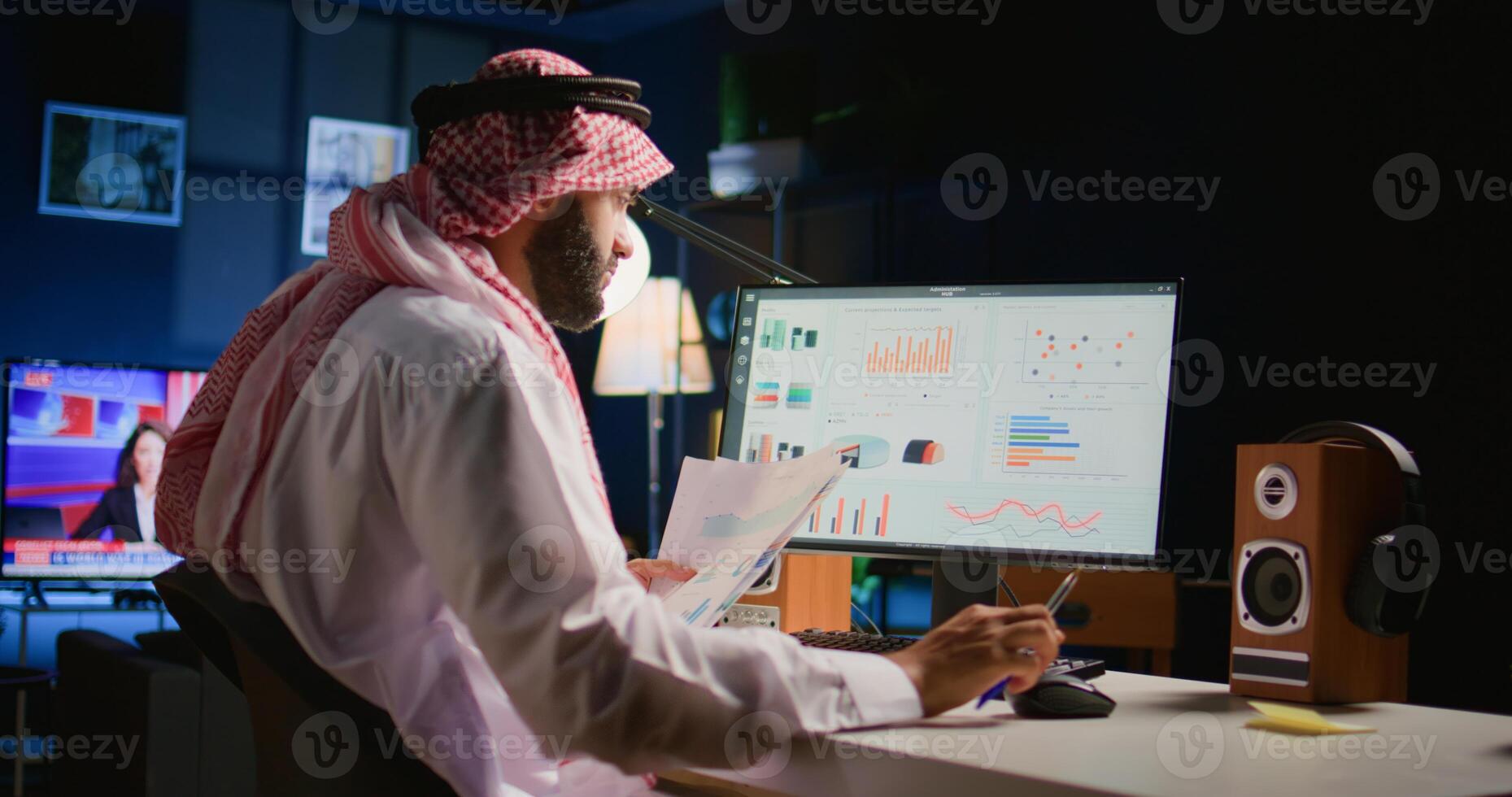 Muslim teleworker crosschecking analytics statistical data set with paperwork while remotely working in apartment office. Middle Eastern manager optimizing key performance indicators photo