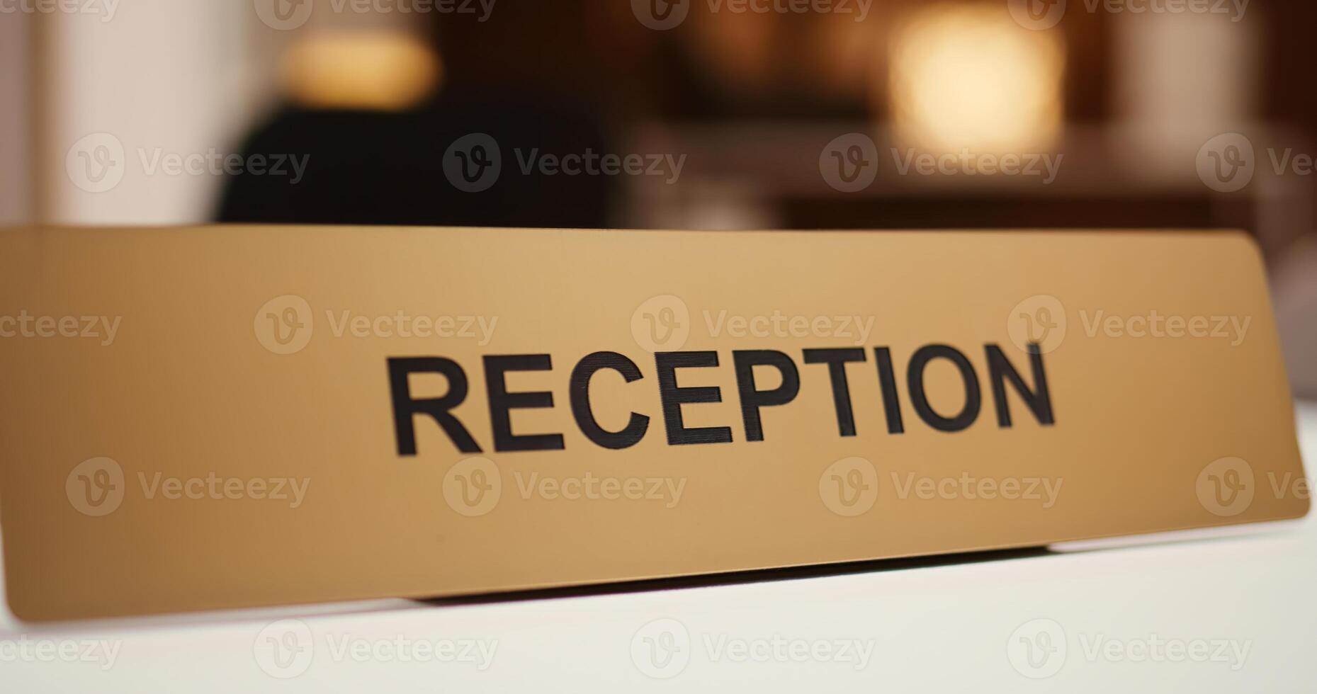 Extreme close up of luxury modern hospitality industry resort check in reception counter sign. Empty clean front desk in stylish travel accommodation resort lounge interior photo