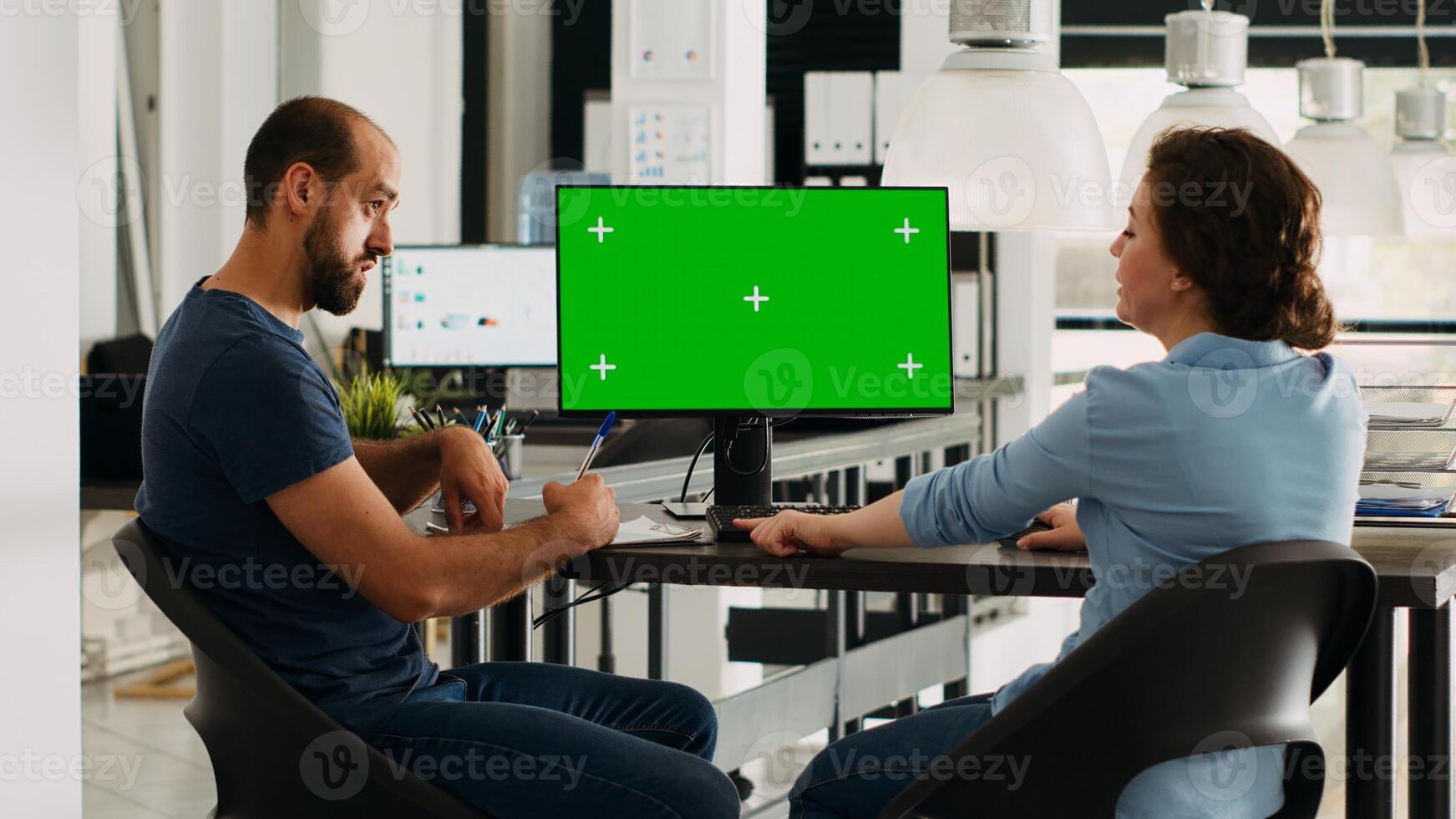 Startup team looking at pc with greenscreen, small business office desk. Company workers analyzing isolated copyspace template, doing teamwork for income development, chromakey on display. photo