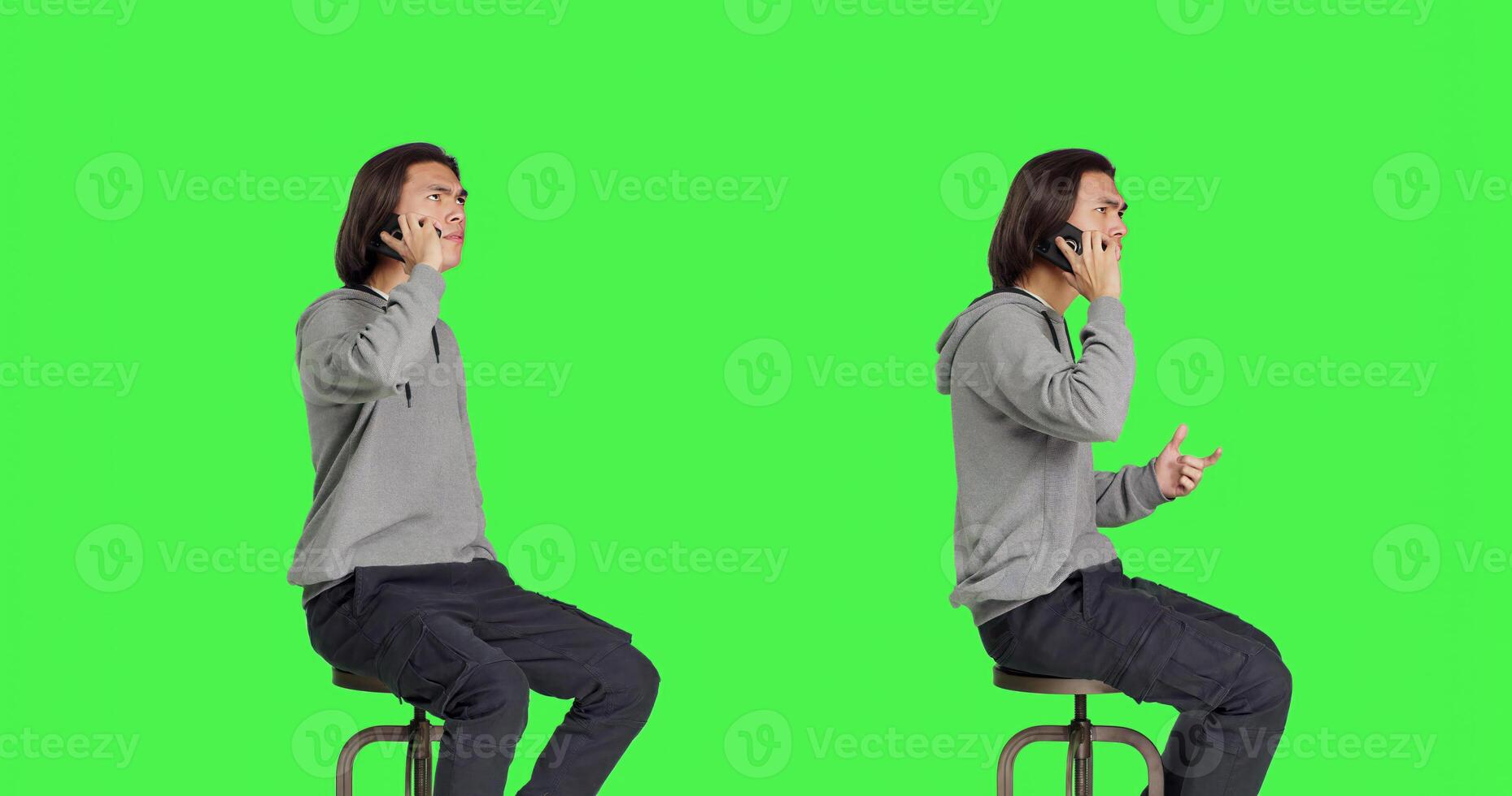 Modern guy making phone calls on camera, sitting on chair against greenscreen backdrop and having remote conversation. Young person being relaxed talking to friends, telephone line. photo