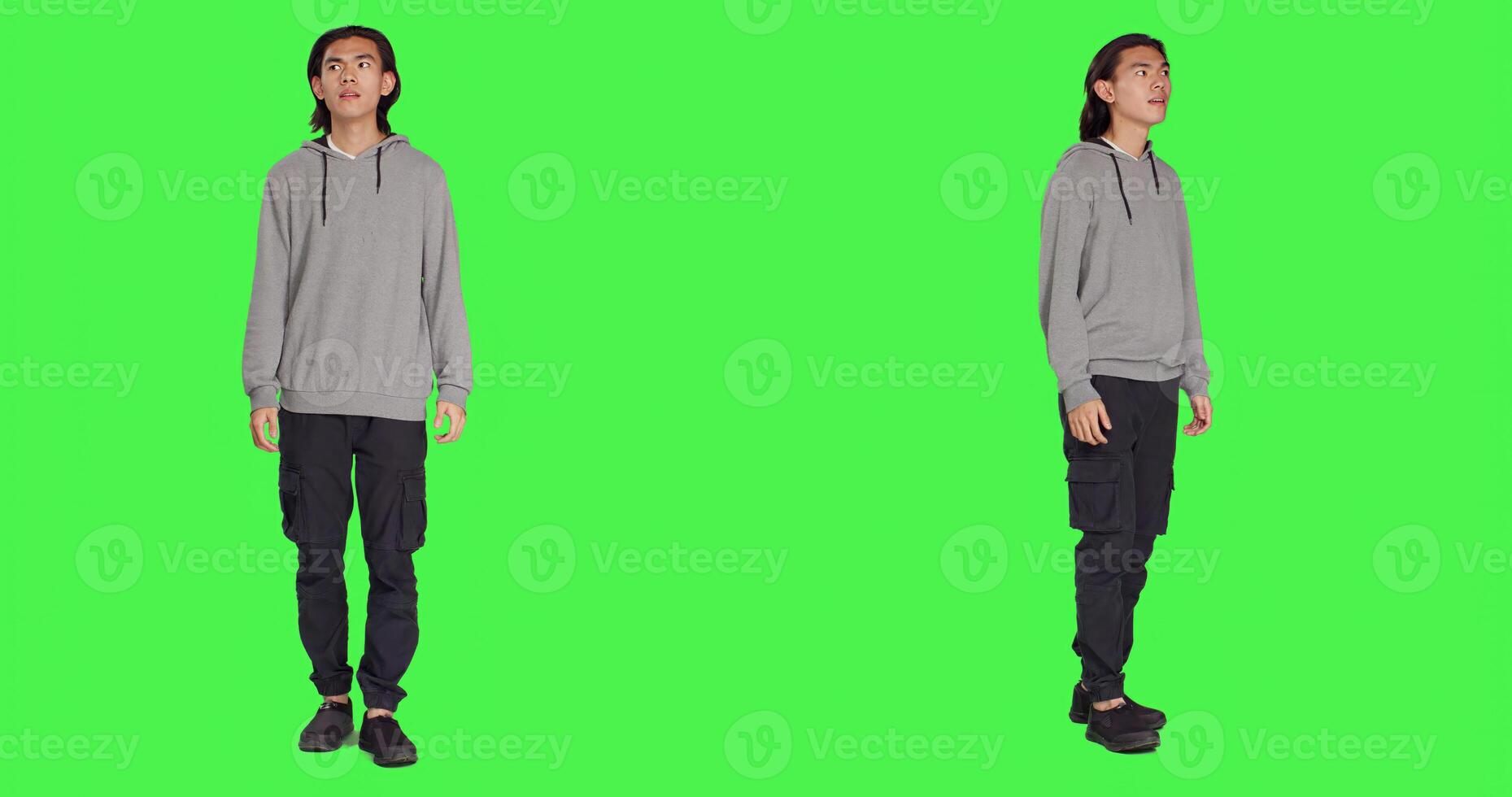Male model having shocked reaction after seeing something, saying wow and being surprised by it. Asian person in shock admiring beautiful view, feeling pleased over greenscreen. photo