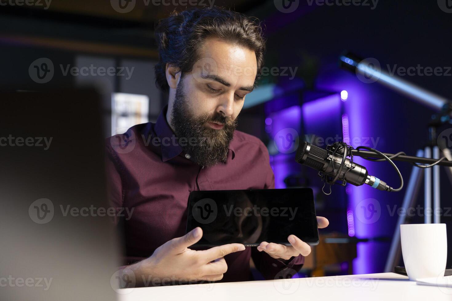 Content creator in studio filming tech tutorial on how to do maintenance on broken tablet. Technology internet show host teaching subscribers how to open and fix digital device photo