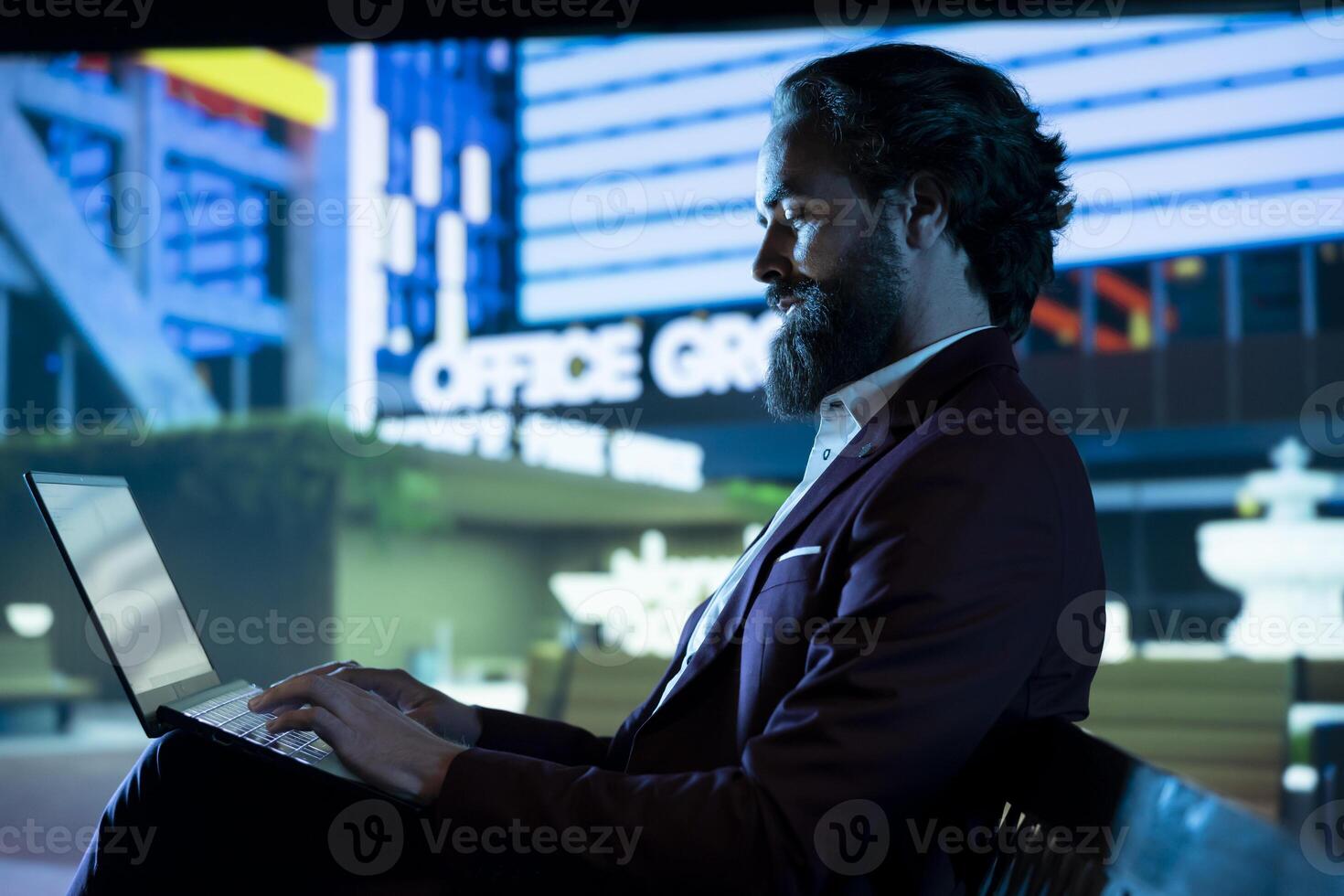 Chief executive director in suit using laptop outdoors, working on pc at night on international business expansion. Workaholic CEO reviewing capital investment updates after hours. photo