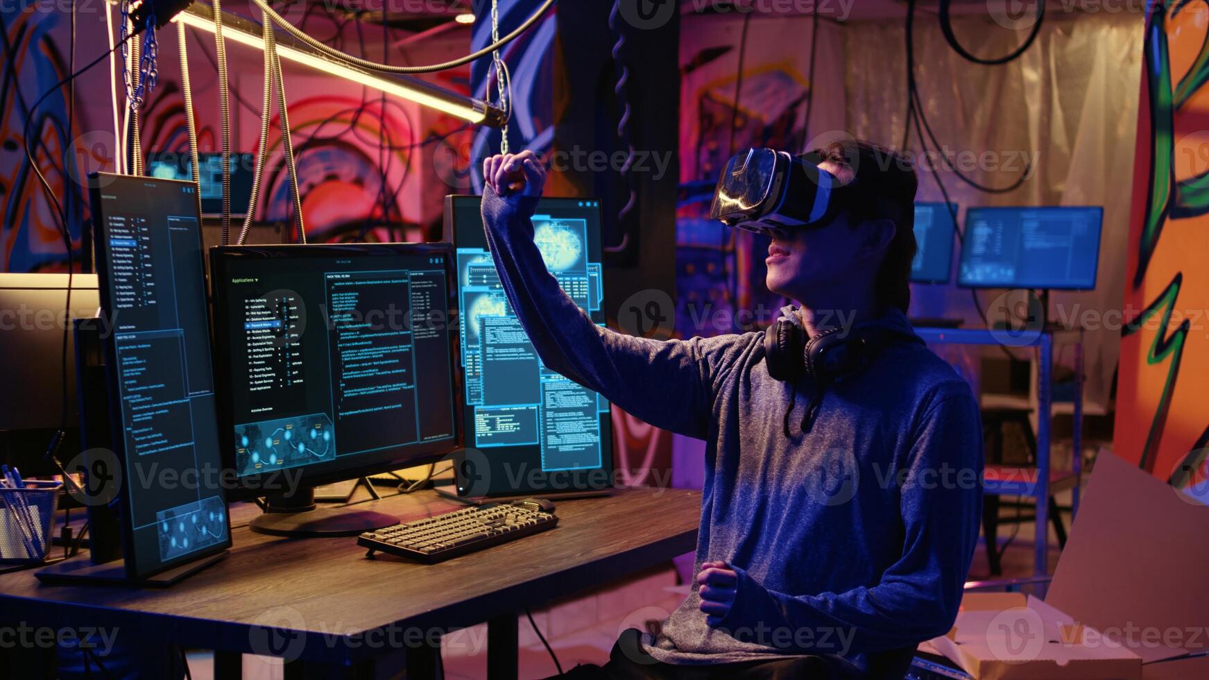 Hacker using virtual reality goggles technology to steal sensitive data by taking advantage of security breaches. Cybercriminal in hidden base using VR headset to gain unauthorized access to systems photo